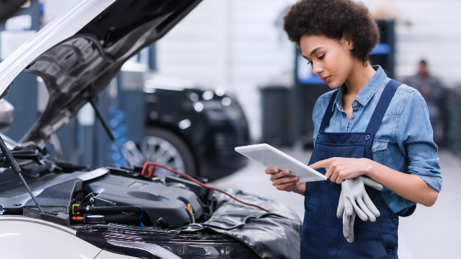 Mechanic checking battery health using Delphi Diagnostic tools.