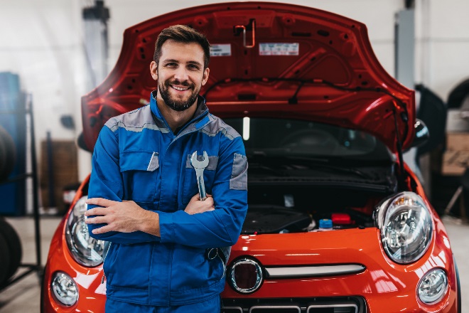 Technician is standing in front of the opened car